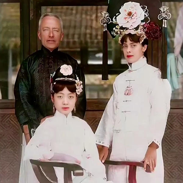 Two women and a man in traditional Chinese clothing pose for the camera.